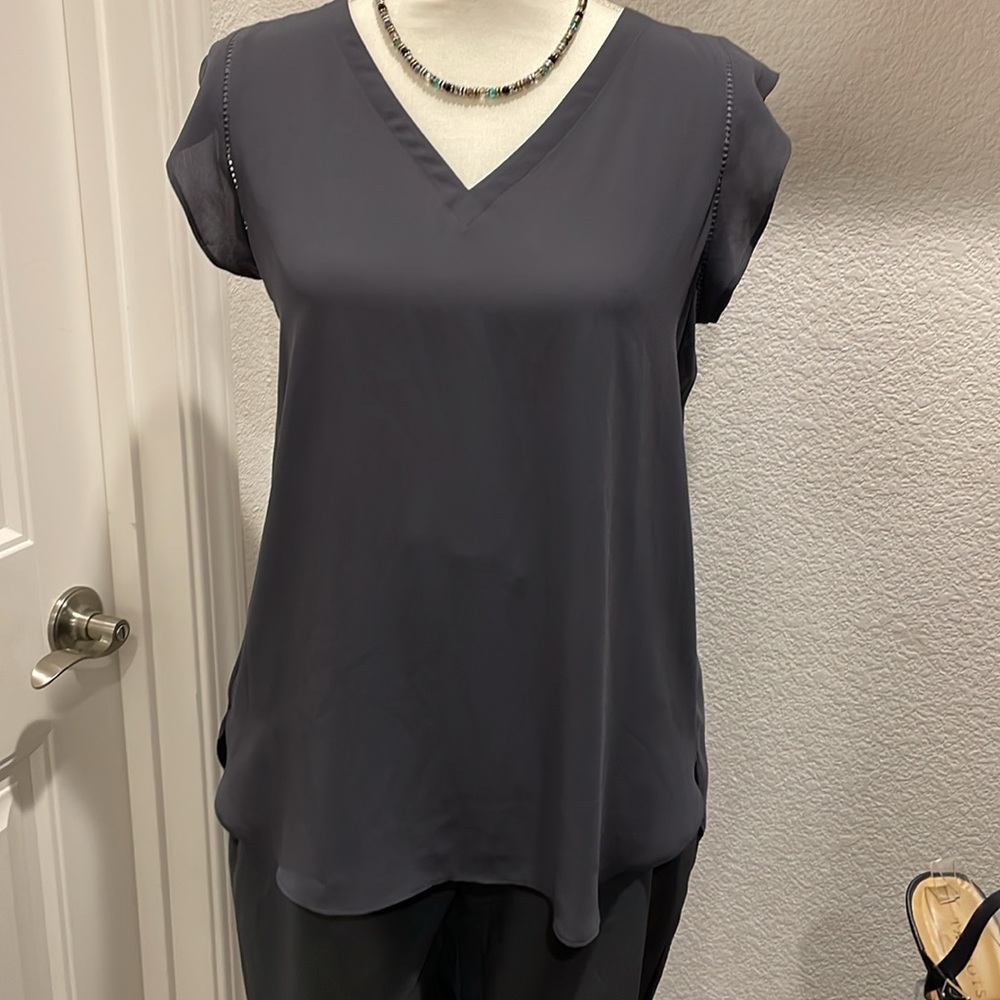Loft V neck blouse. Flutter sleeve with cutouts. Longer back hem. Lightweight.